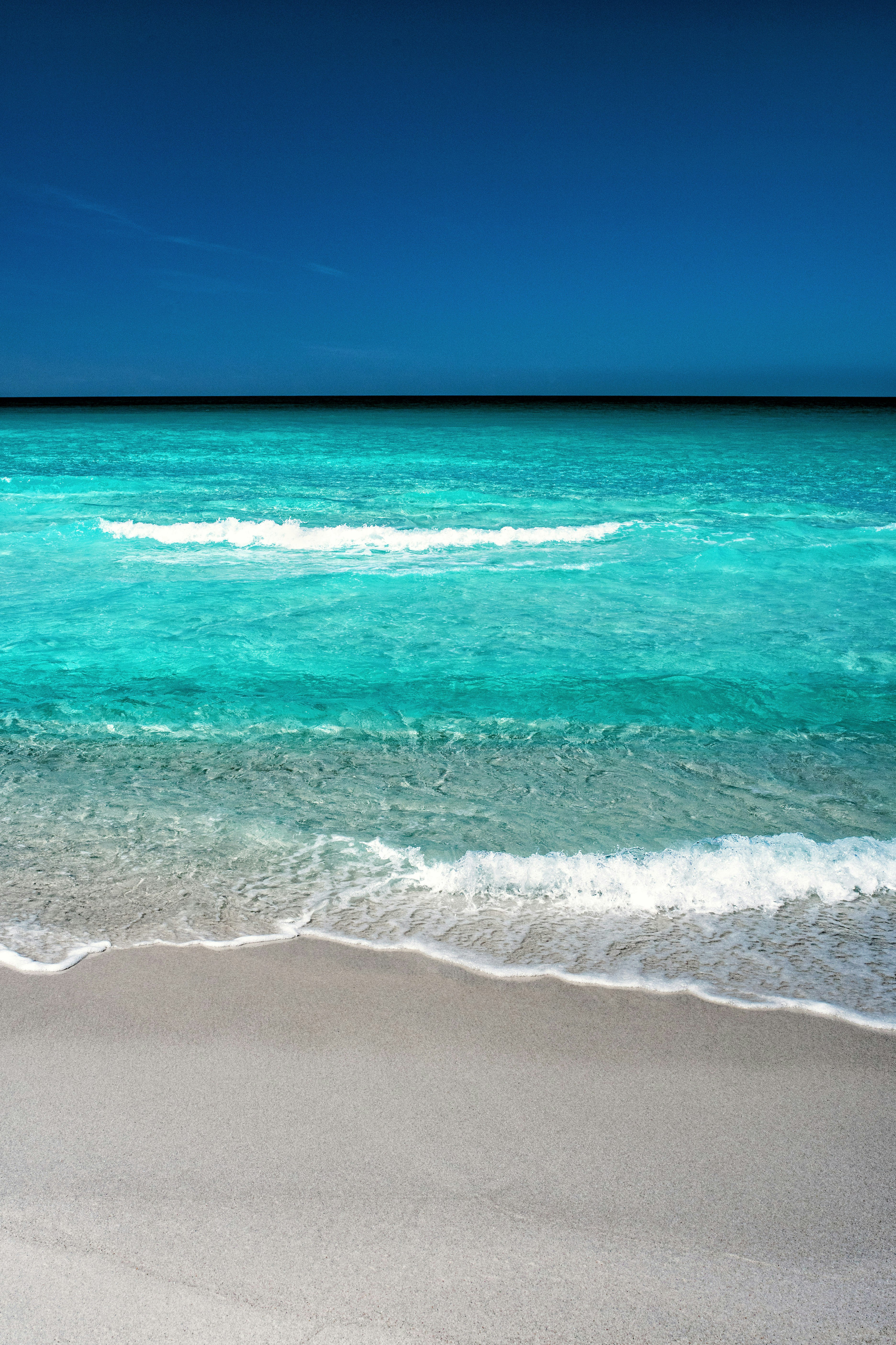 blue beach under clear blue sky